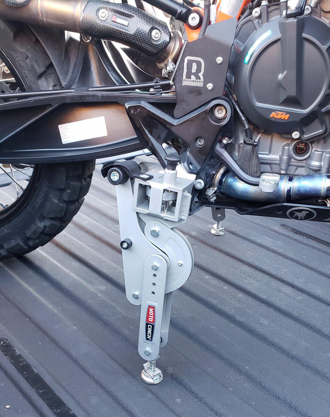 Moto Cinch strapless tie-down on a motorcycle foot peg